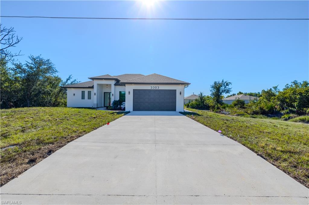 3303 24th Street Southwest Lehigh Acres, FL 33976 - Photo 25 of 25 a front view of a house with yard and green space