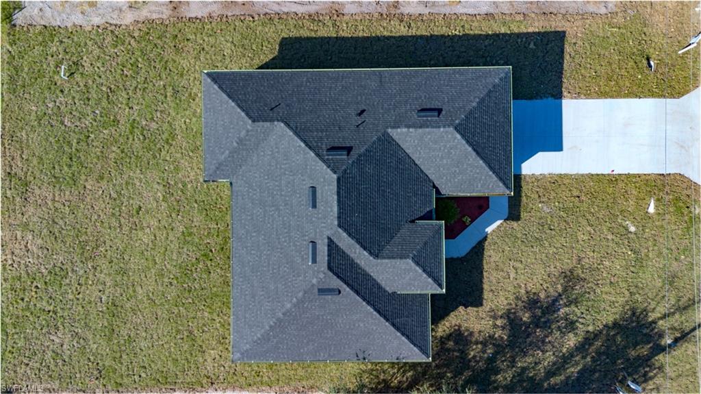 3303 24th Street Southwest Lehigh Acres, FL 33976 - Photo 4 of 25 a aerial view of a house with a yard