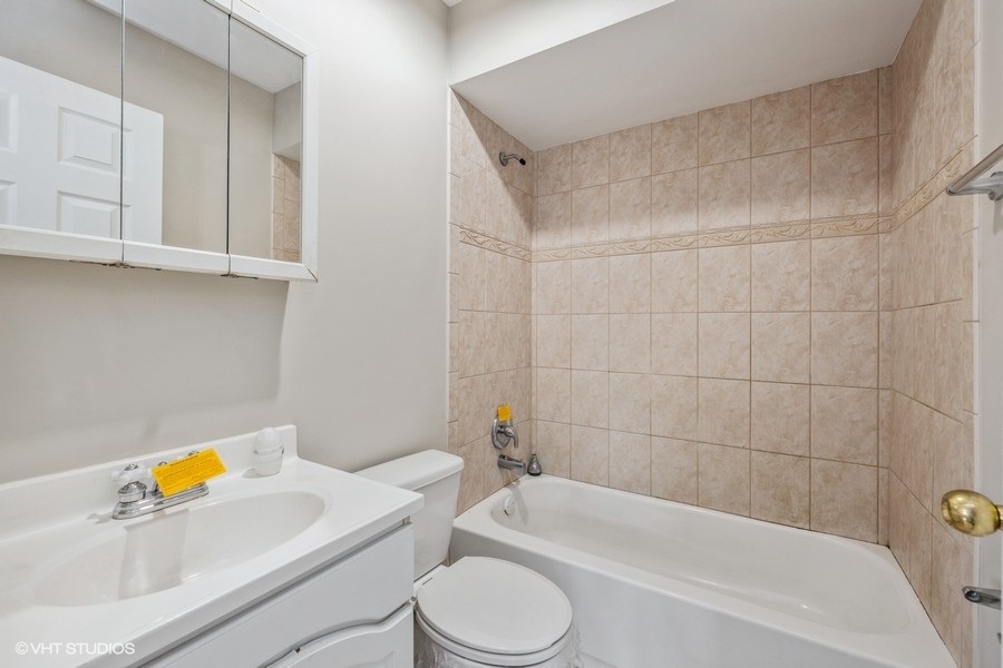 4418 West 55th Street, Unit 5 Chicago, IL 60632 - Photo 11 of 15 a bathroom with a toilet and a bath tub