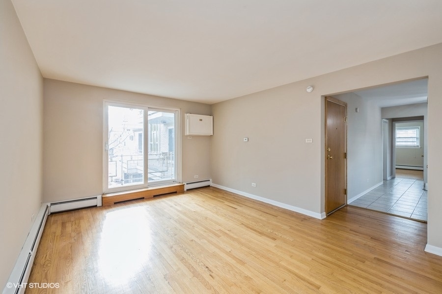 4418 West 55th Street, Unit 5 Chicago, IL 60632 - Photo 3 of 15 wooden floor in an empty room with a window