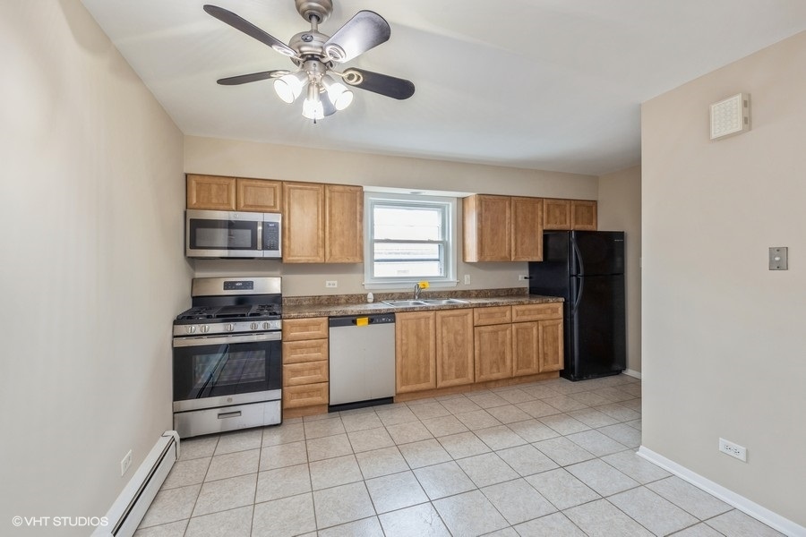 4418 West 55th Street, Unit 5 Chicago, IL 60632 - Photo 7 of 15 a kitchen with stainless steel appliances granite countertop a stove cabinets and refrigerator