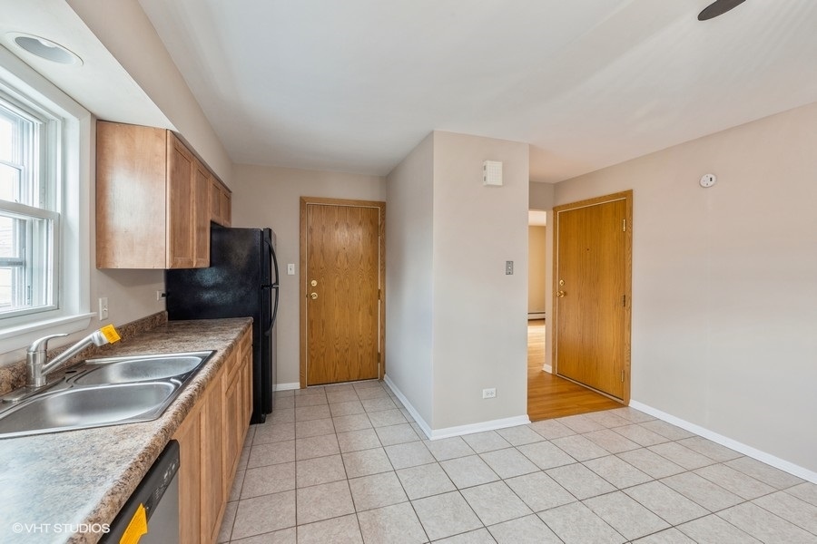 4418 West 55th Street, Unit 5 Chicago, IL 60632 - Photo 8 of 15 a kitchen that has a sink a stove and a refrigerator