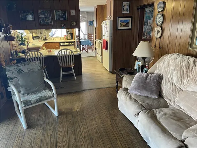 a dining room with furniture and wooden floor