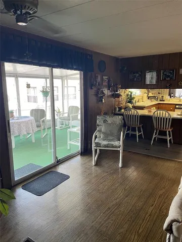 a living room with furniture and a floor to ceiling window