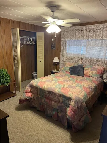 a bedroom with a bed a mirror and a chandelier