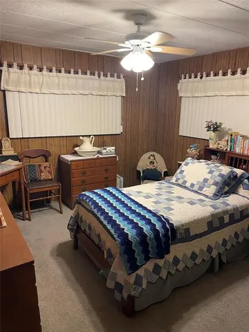 a bedroom with a bed and a desk