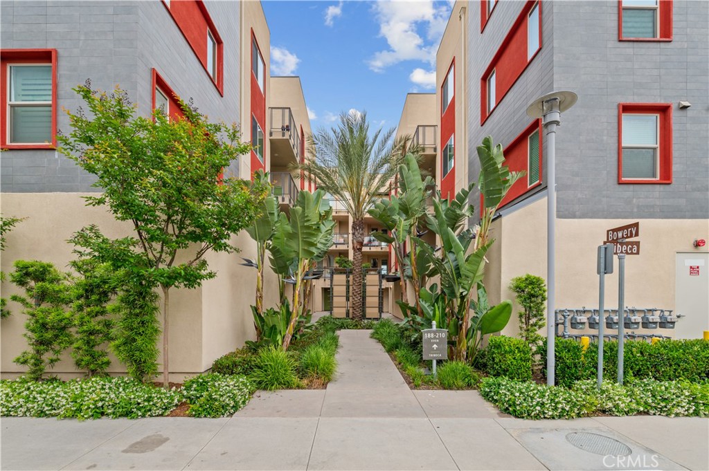 a front view of multi story residential apartment building with yard