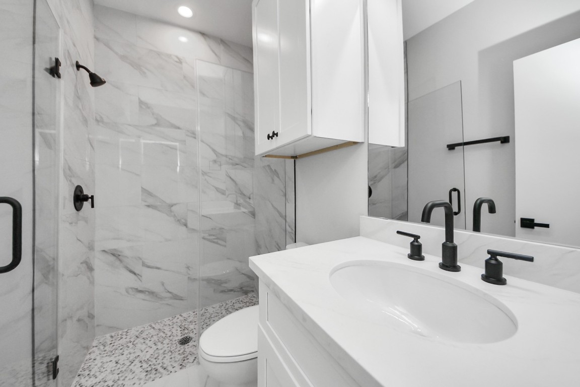 3419 Arlington Street Houston, TX 77018 - Photo 11 of 44 a bathroom with a sink a toilet and shower