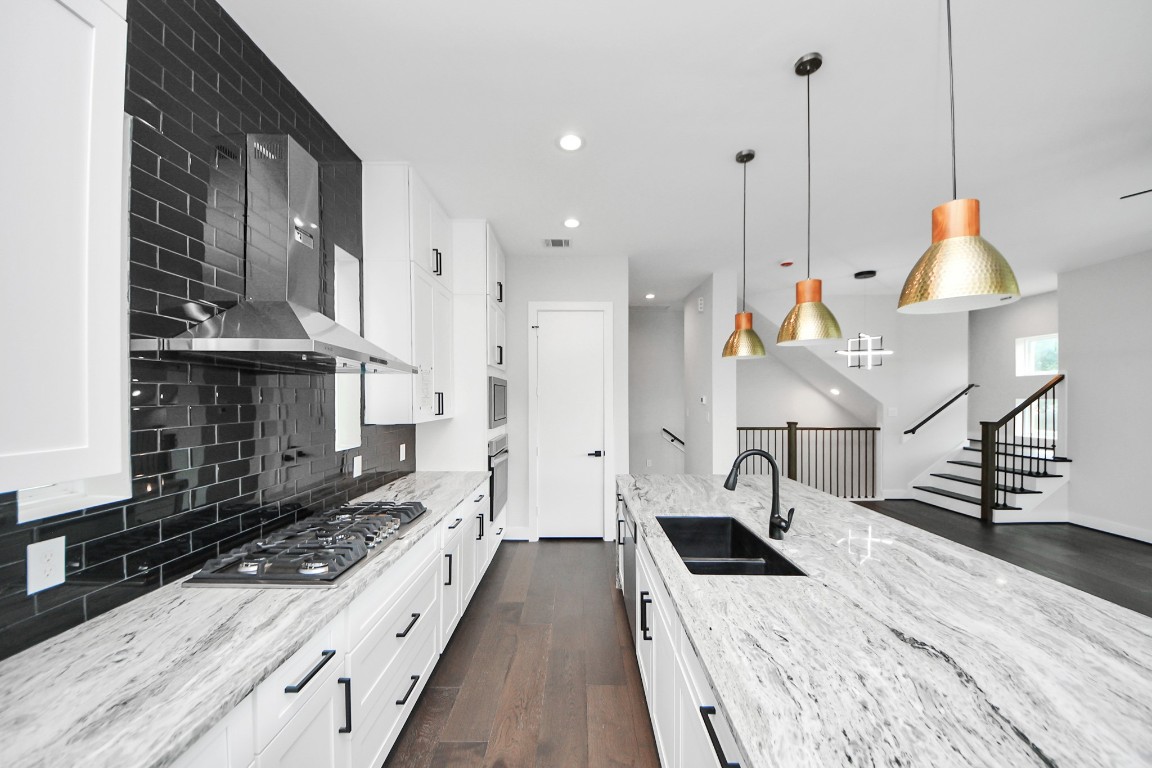3419 Arlington Street Houston, TX 77018 - Photo 18 of 44 a kitchen with stainless steel appliances kitchen island wooden cabinets a stove a sink and a wooden floors