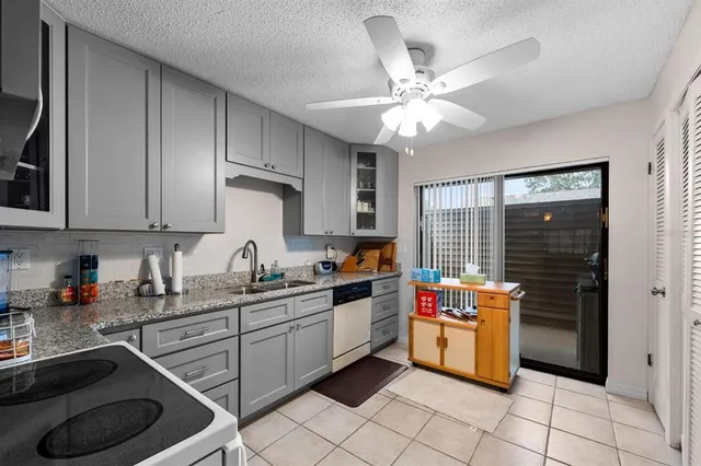 a kitchen with a sink cabinets and window