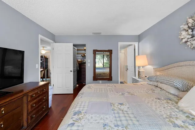a bedroom with furniture and flat screen tv