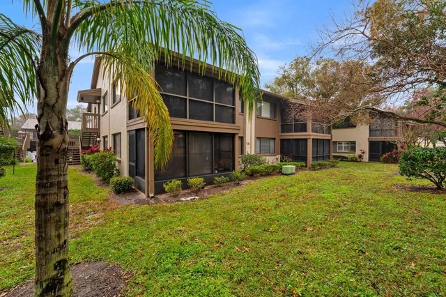 a view of a house with a yard and sitting area