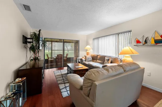 a living room with furniture a lamp and a window