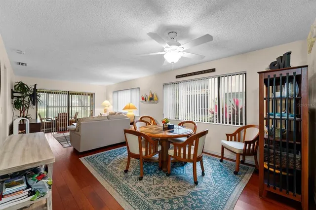 a dining room with furniture a rug and wooden floor