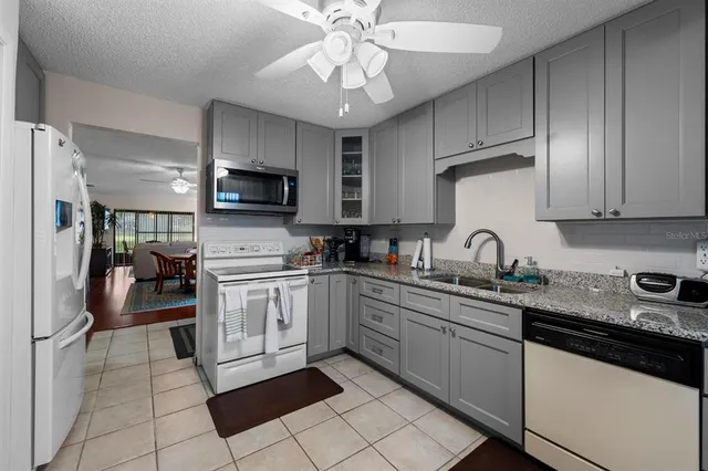 a kitchen with a sink cabinets and stainless steel appliances
