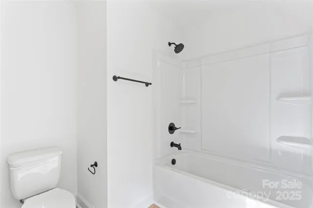 a bathroom with a toilet and a bathtub