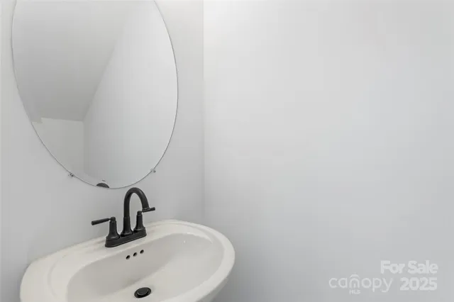 a bathroom with a sink and mirror