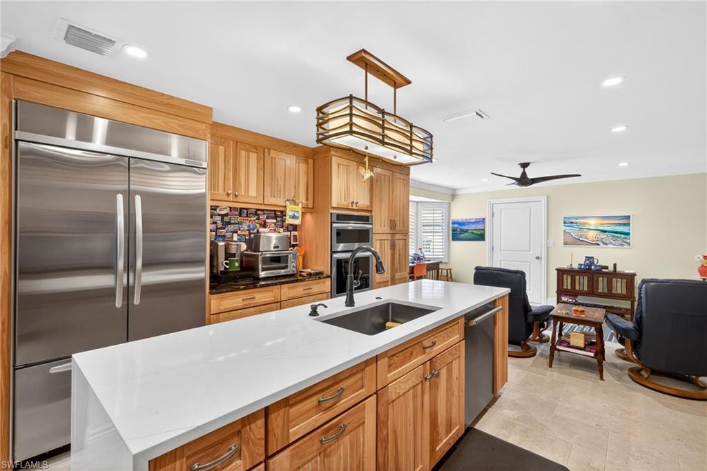 4030 Crayton Road, Unit C2 Naples, FL 34103 - Photo 11 of 32 a kitchen with stainless steel appliances a sink a stove and a refrigerator