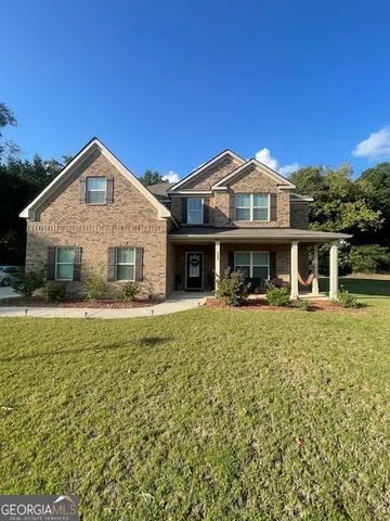 a front view of a house with a garden and porch