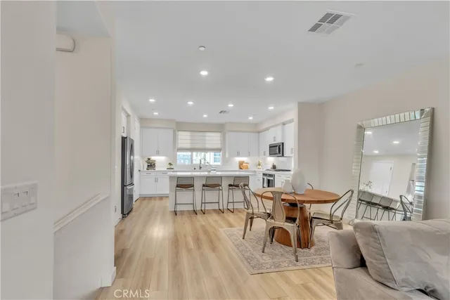 a kitchen with white cabinets and refrigerator