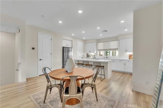 a kitchen with stainless steel appliances granite countertop a stove refrigerator sink and cabinets
