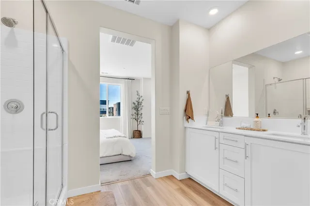 a bedroom with a bed and a view of en suite bathroom