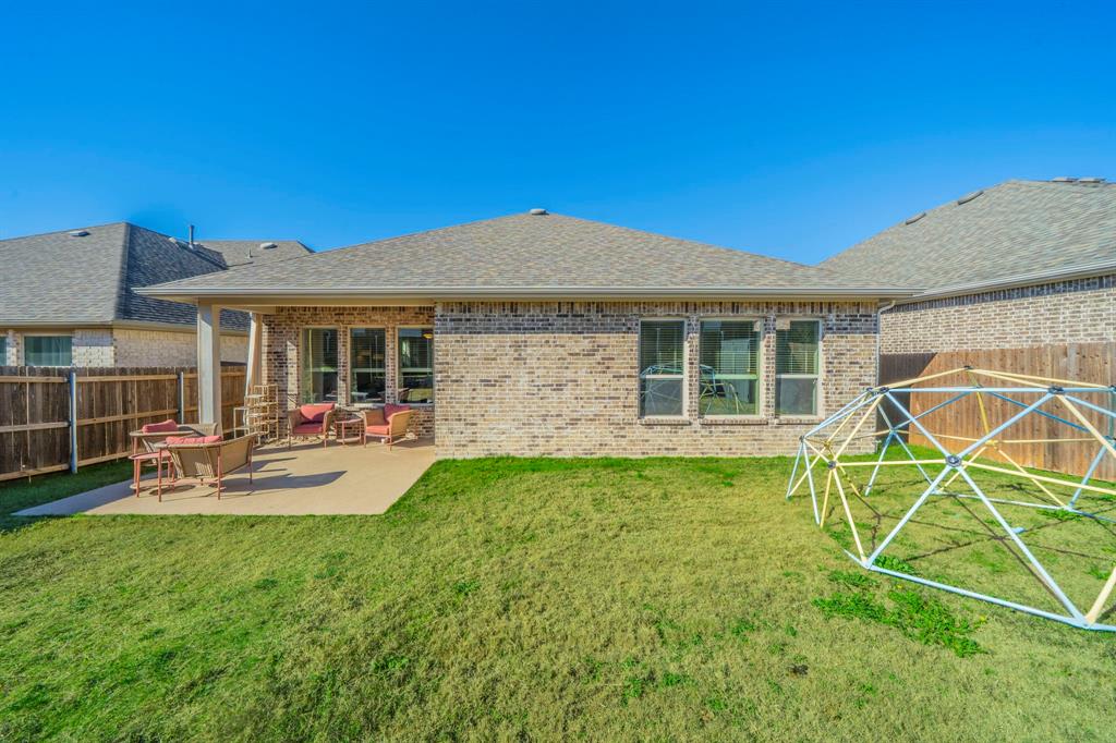 1885 Arbor Drive Forney, TX 75126 - Photo 23 of 33 Back of property with a fenced backyard, a patio, and brick siding