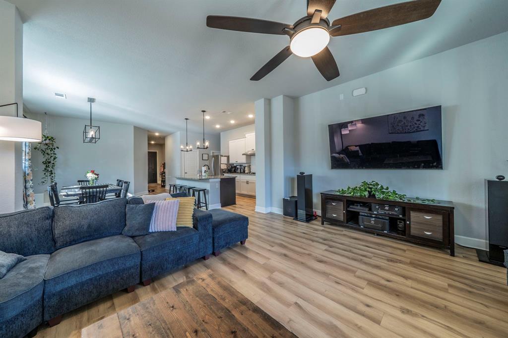 1885 Arbor Drive Forney, TX 75126 - Photo 3 of 33 Living area featuring light wood-style flooring, a ceiling fan, and a chandelier