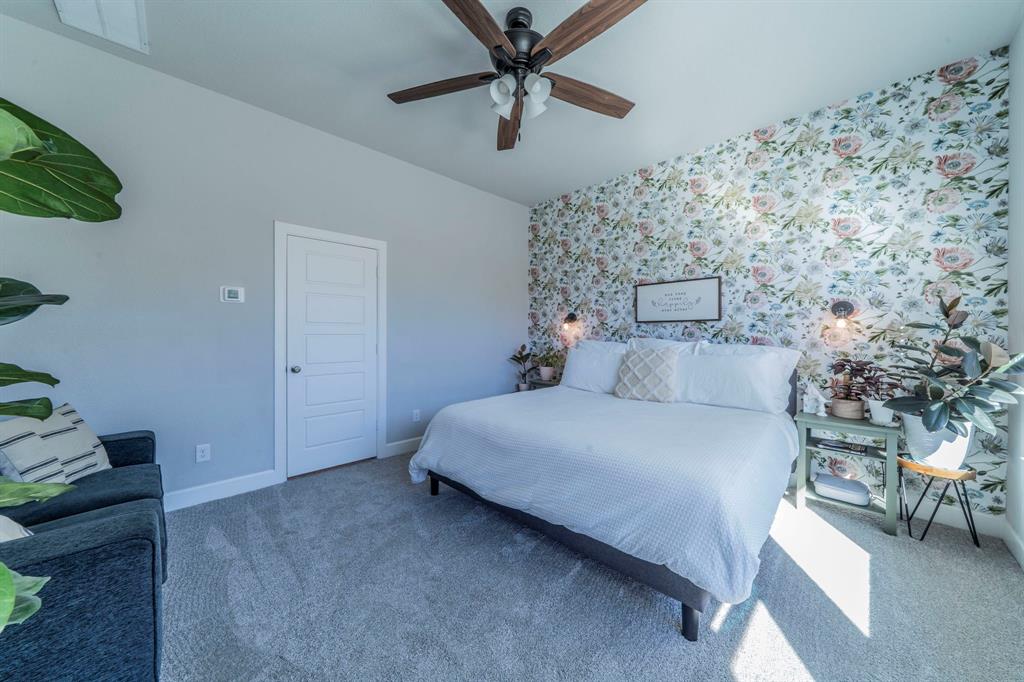 1885 Arbor Drive Forney, TX 75126 - Photo 7 of 33 Carpeted bedroom with an accent wall, wallpapered walls, and ceiling fan