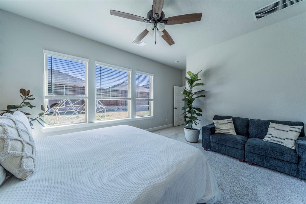 1885 Arbor Drive Forney, TX 75126 - Photo 8 of 33 Carpeted bedroom with a ceiling fan and baseboards