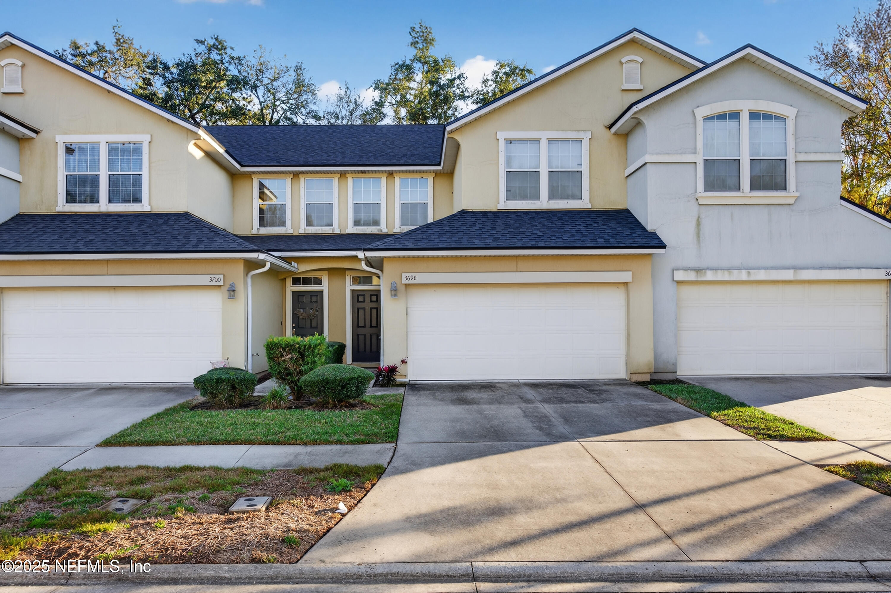 a front view of a house with a yard and garage