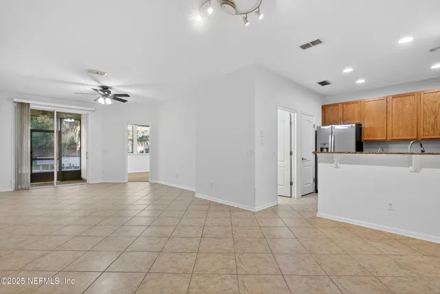 an empty room with a empty space and a ceiling fan