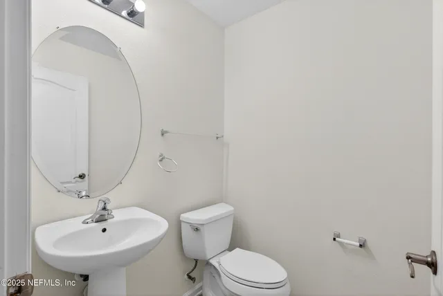 an empty room with a ceiling fan and window