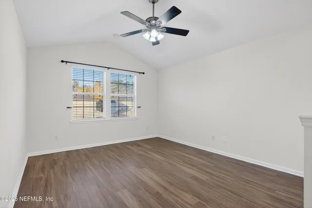 a bathroom with a granite countertop sink a toilet and a mirror