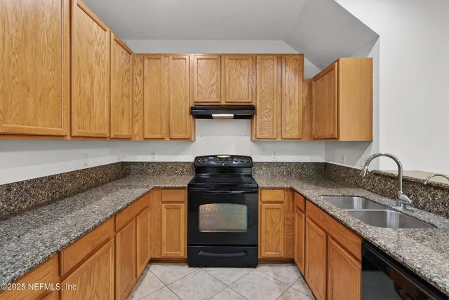 a kitchen with a sink and a toilet