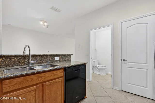 a view of a kitchen with a sink and dishwasher