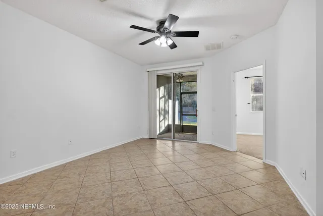 a view of a livingroom with a ceiling fan and window