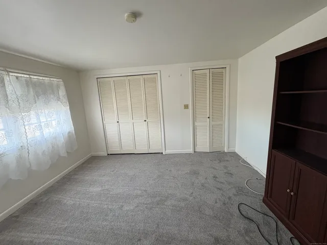 a view of an empty room with a kitchen
