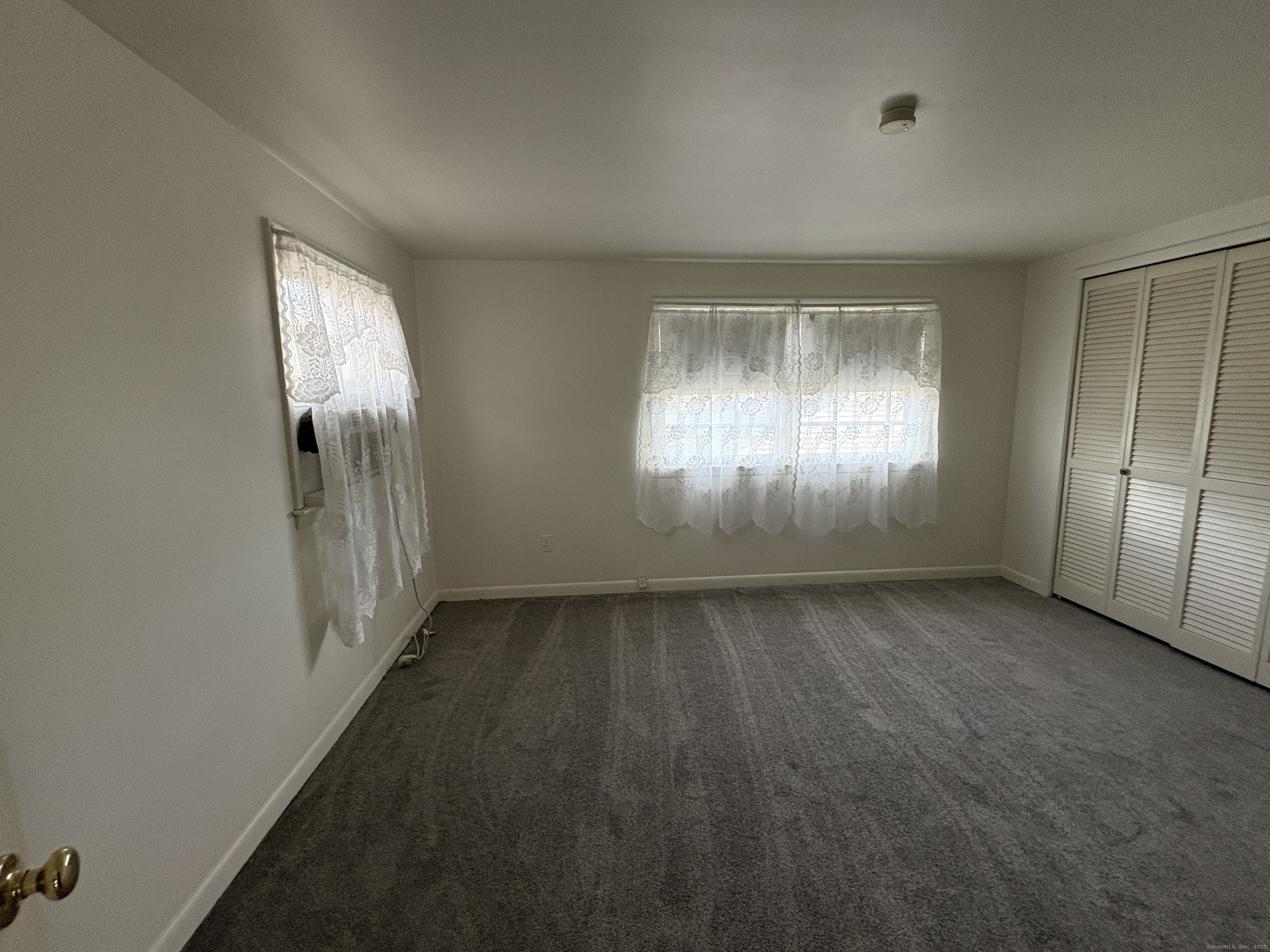 255 Fairfield Woods Road Fairfield, CT 06825 - Photo 15 of 22 an empty room with windows and entrance