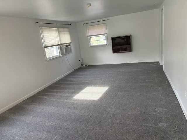 a view of empty room with a flat screen tv