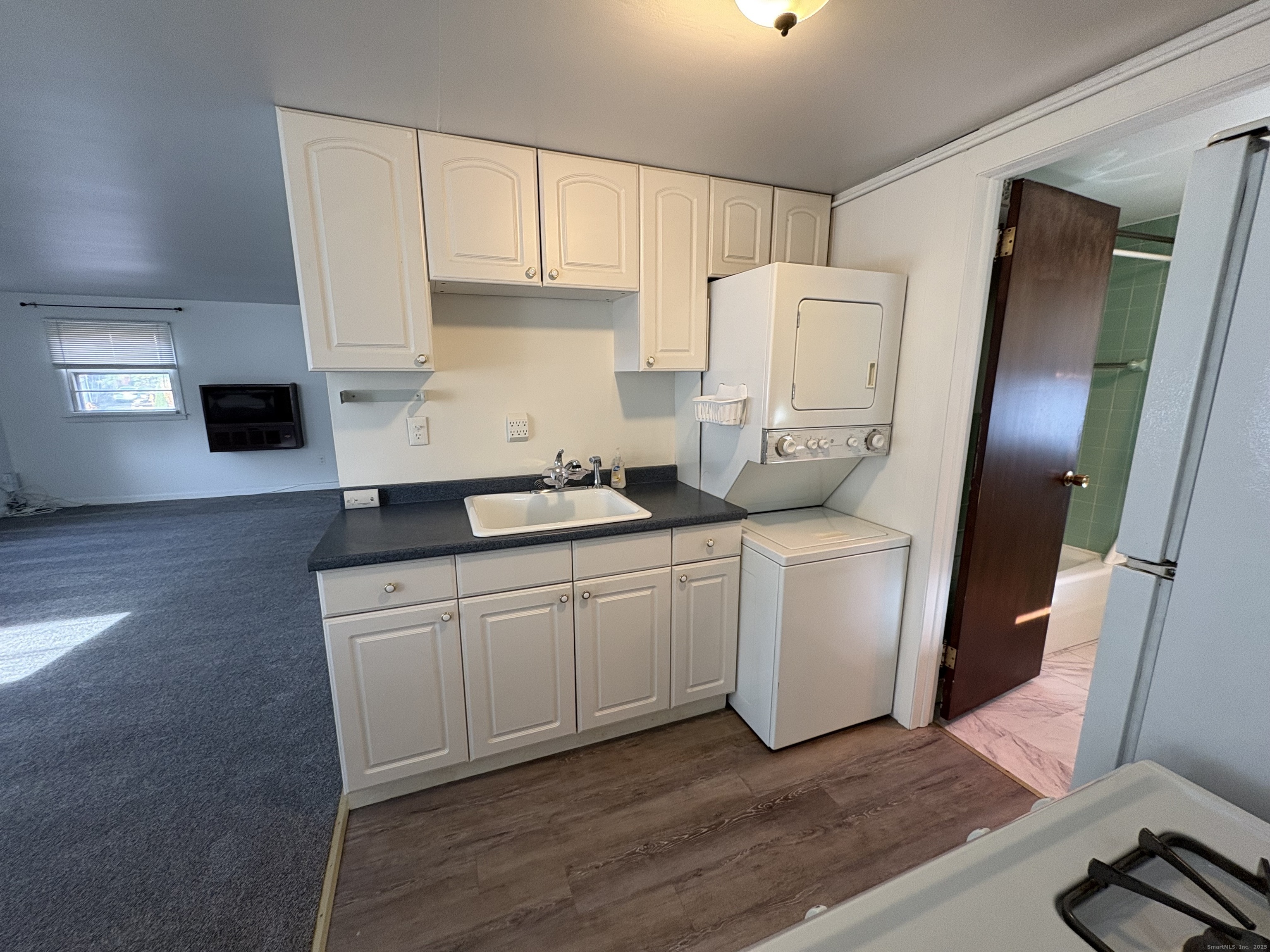 255 Fairfield Woods Road Fairfield, CT 06825 - Photo 8 of 22 a kitchen with a sink a refrigerator and cabinets