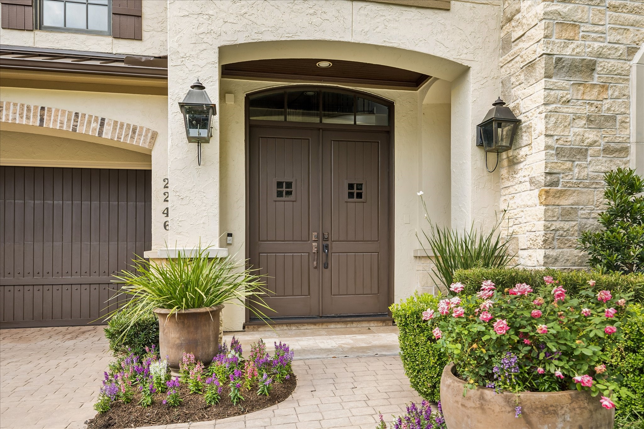 2246 Branard Street Houston, TX 77098 - Photo 2 of 40 Inviting front entry featuring warm wood doors, gas lanterns, and beautifully layered landscaping.