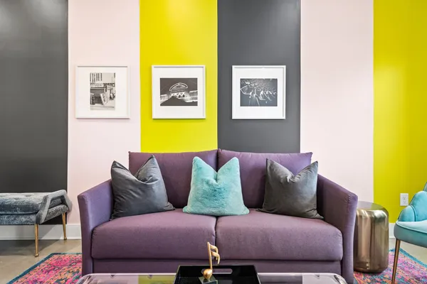 a living room with a couch and painting on the wall