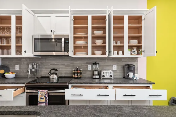 a kitchen with stainless steel appliances granite countertop a stove and a microwave