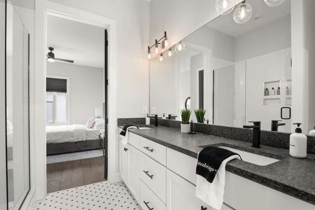a bathroom with double vanity sinks and a mirror
