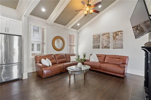 a living room with furniture and kitchen view