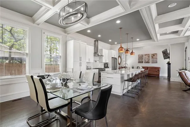 a dining room with furniture and wooden floor