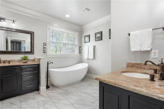 a bathroom with a tub sink and mirror
