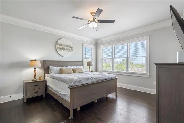 a large bed sitting in a bedroom next to a window