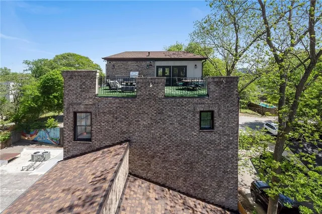 an aerial view of a house with swimming pool and big yard